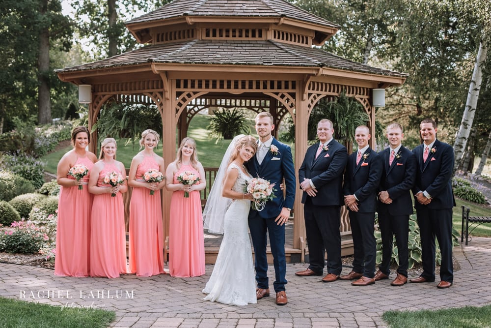 A wedding party stands alongside a bride and groom for their wedding photography at Panola Valley Gardens.