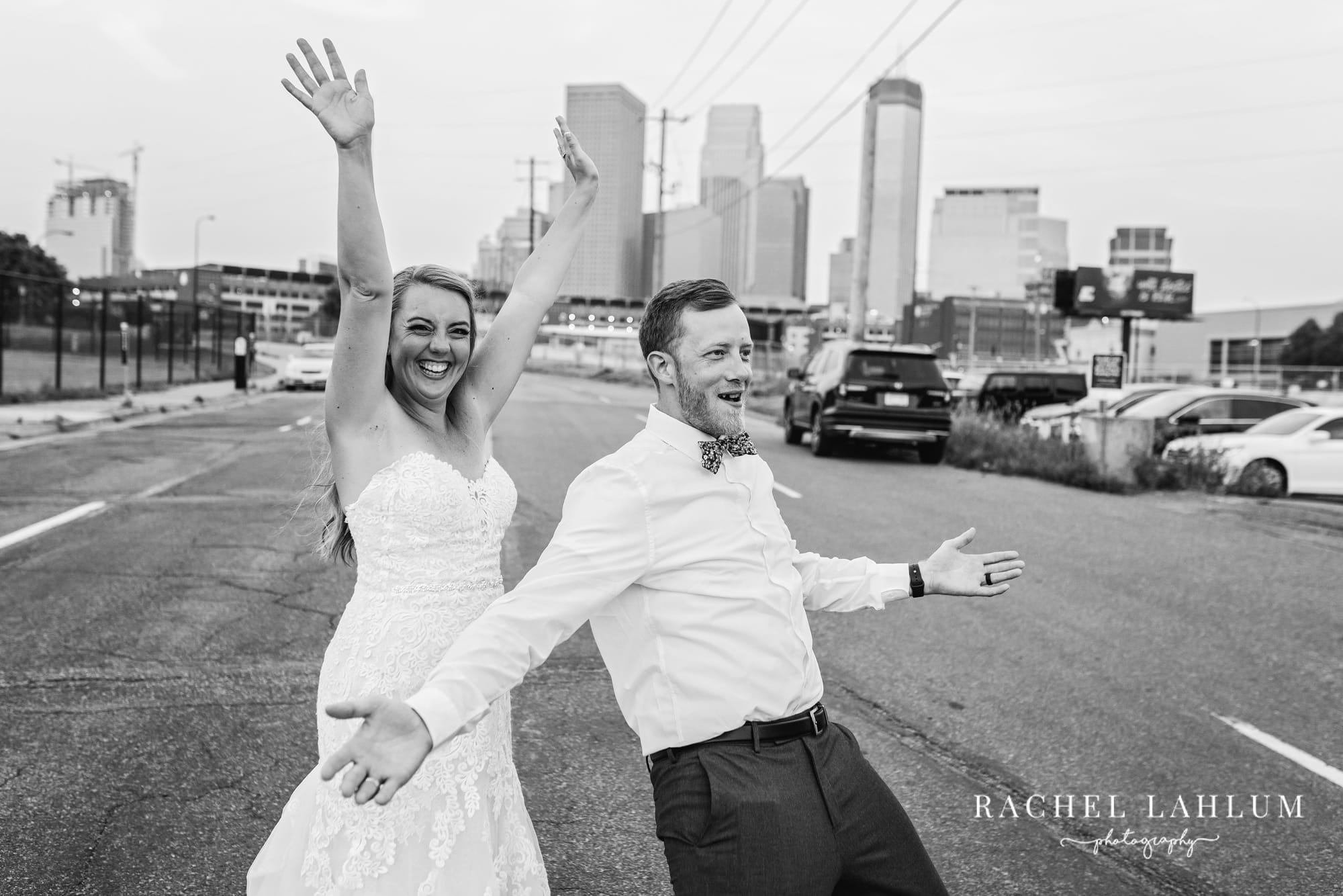 Newly wed couple throw up their arms in celebration outside the Holden Room in the North Loop of Minneapolis. 