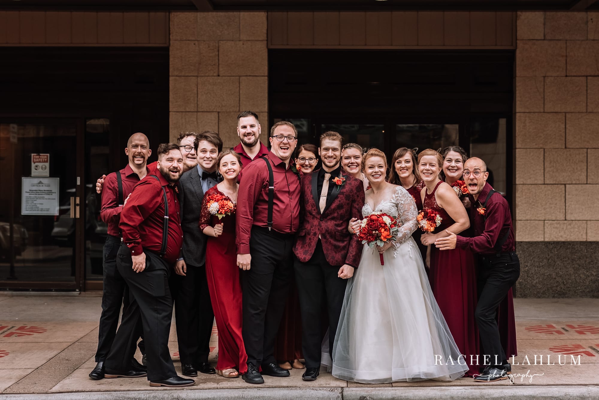 Wedding party gathers for a group photo outside on the streets of Duluth, Minnesota.