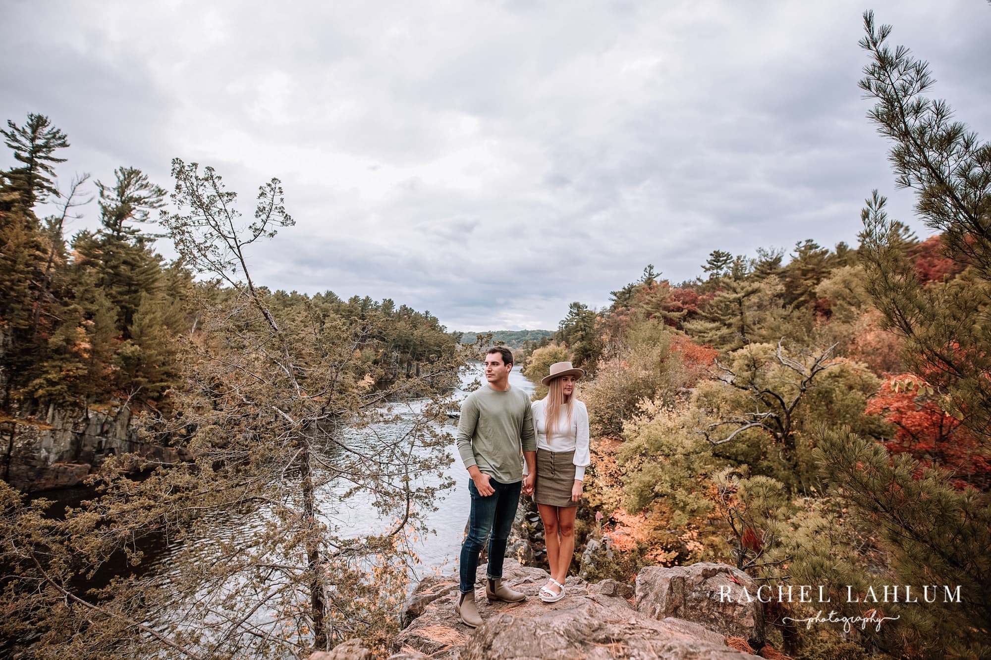 Engaged couple pose during engagement photography session in Taylors Falls, MN.