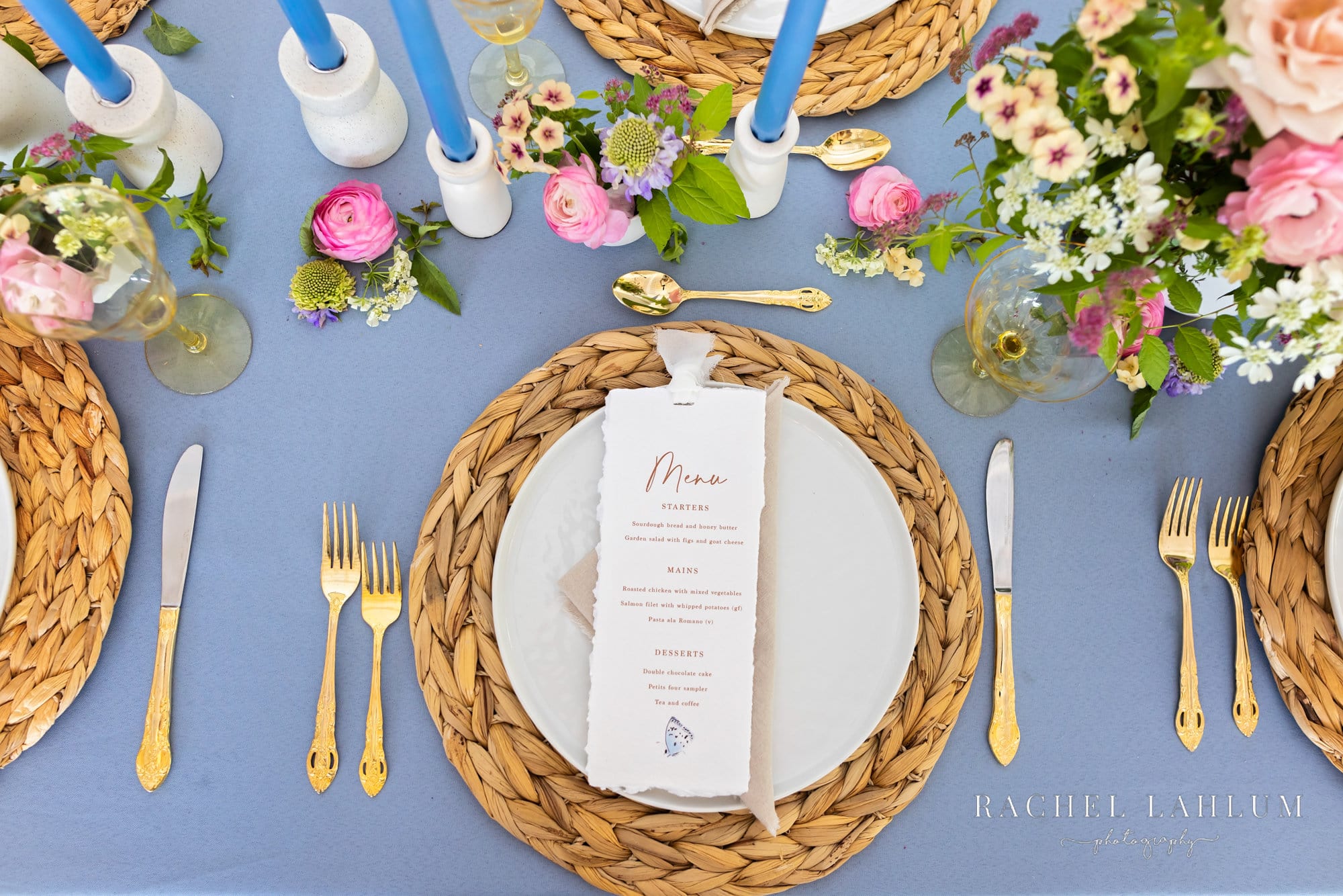 Wedding menu made for stylized wedding photo shoot on top of place setting.