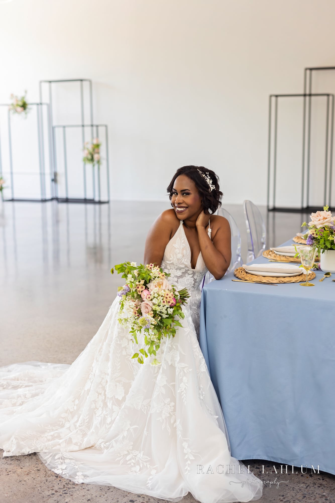 Bride sits at decorated table at Northeast Minneapolis Wedding venue. 