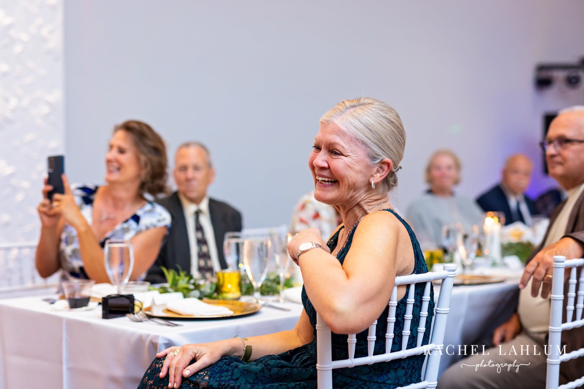 Wedding guests laughs during speeches.