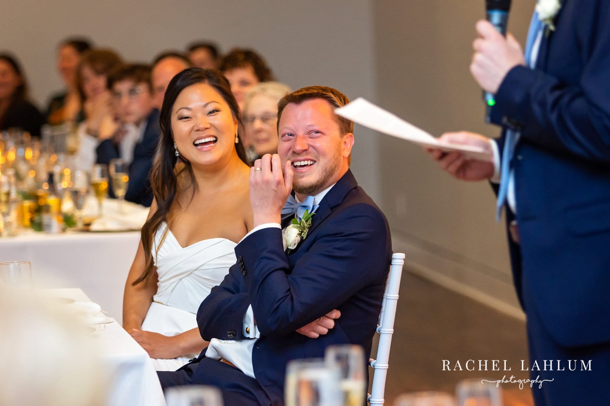 Bride and groom laugh during speeches during reception at The Blaisdell.