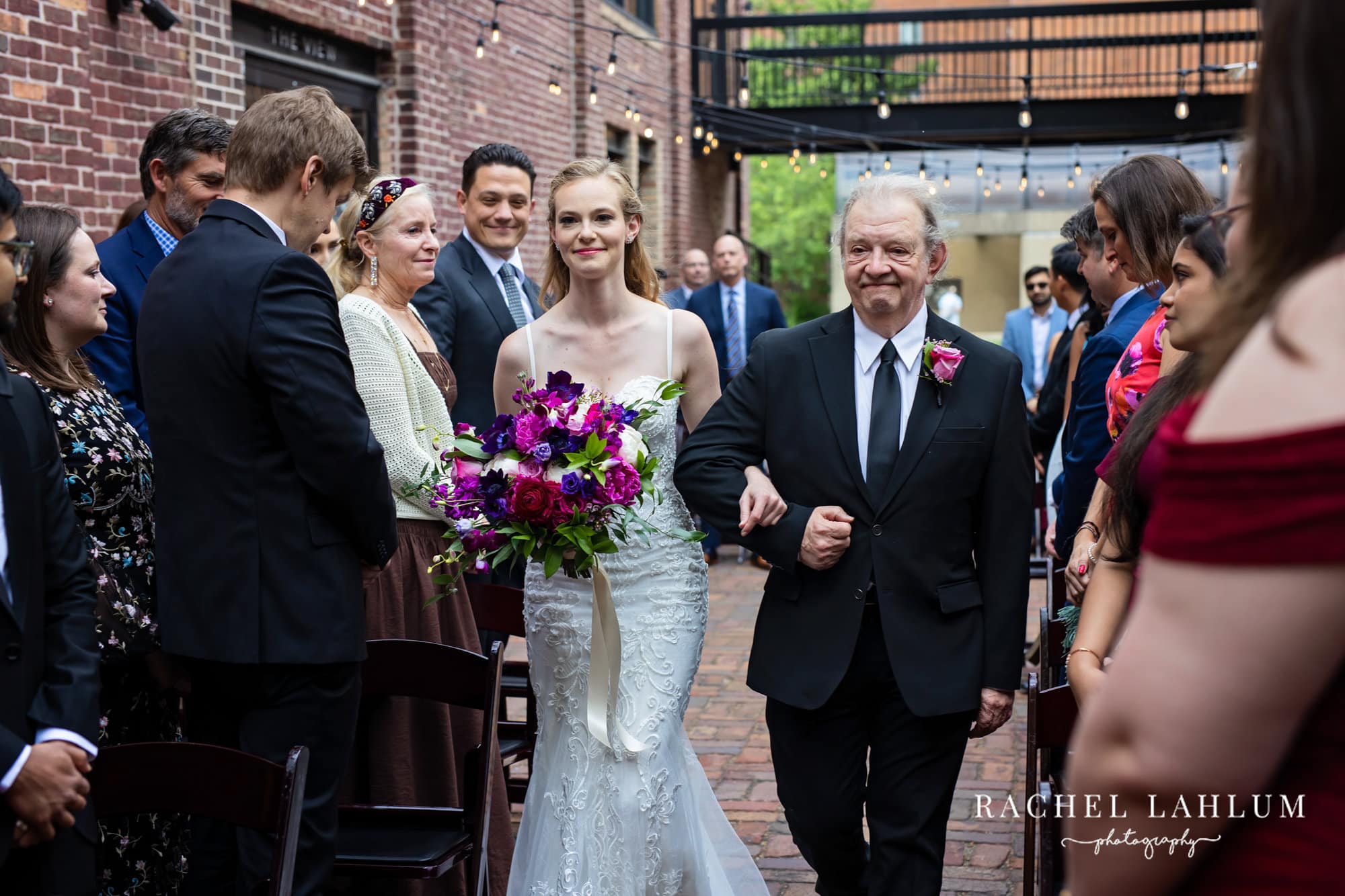 Bride walks down the aisle with her father during wedding at The Minneapolis Event Center.