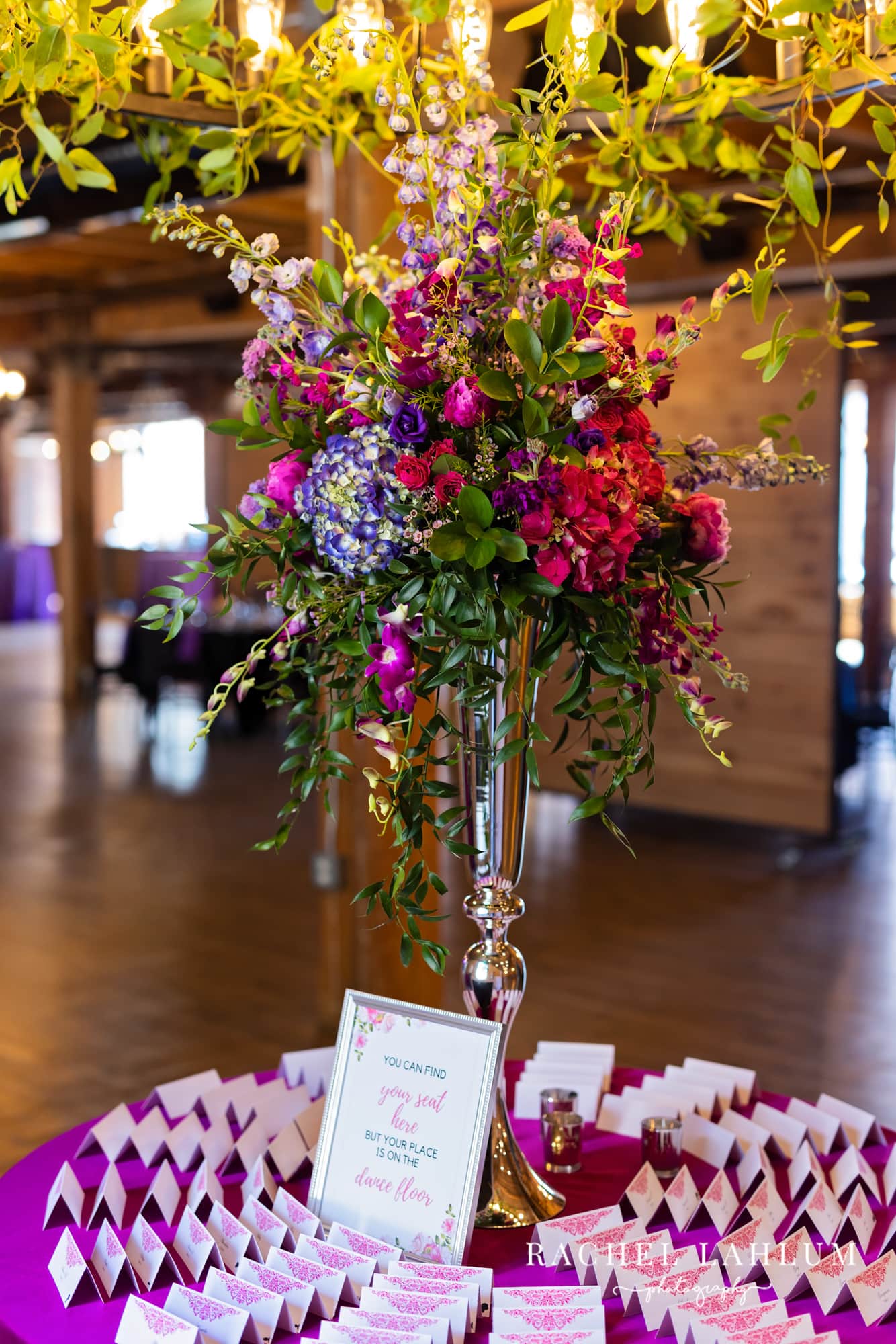 Place cards surround a bouquet of flowers at the wedding reception.