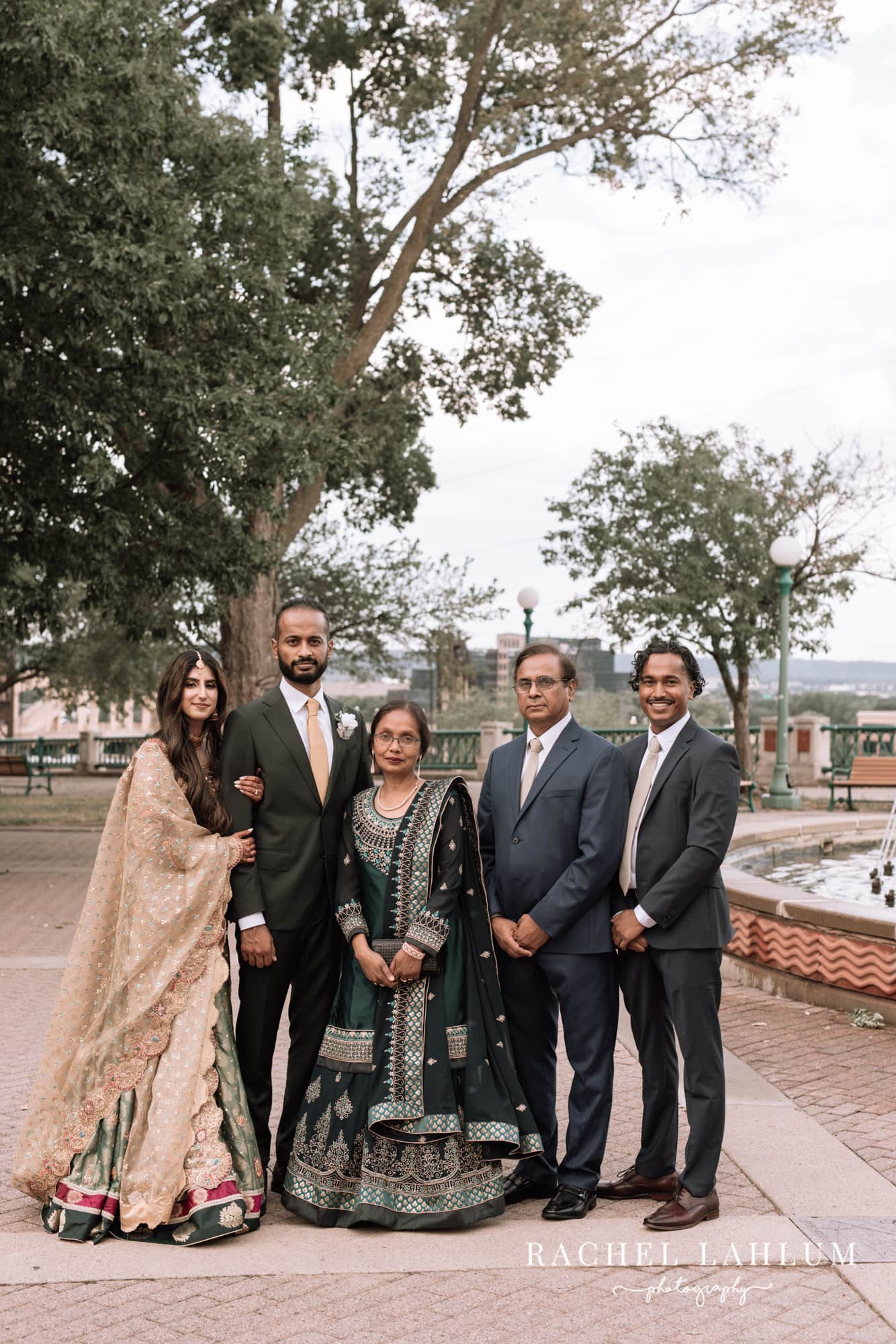 Newly wed couple pose with groom’s family at Irvine Park. 