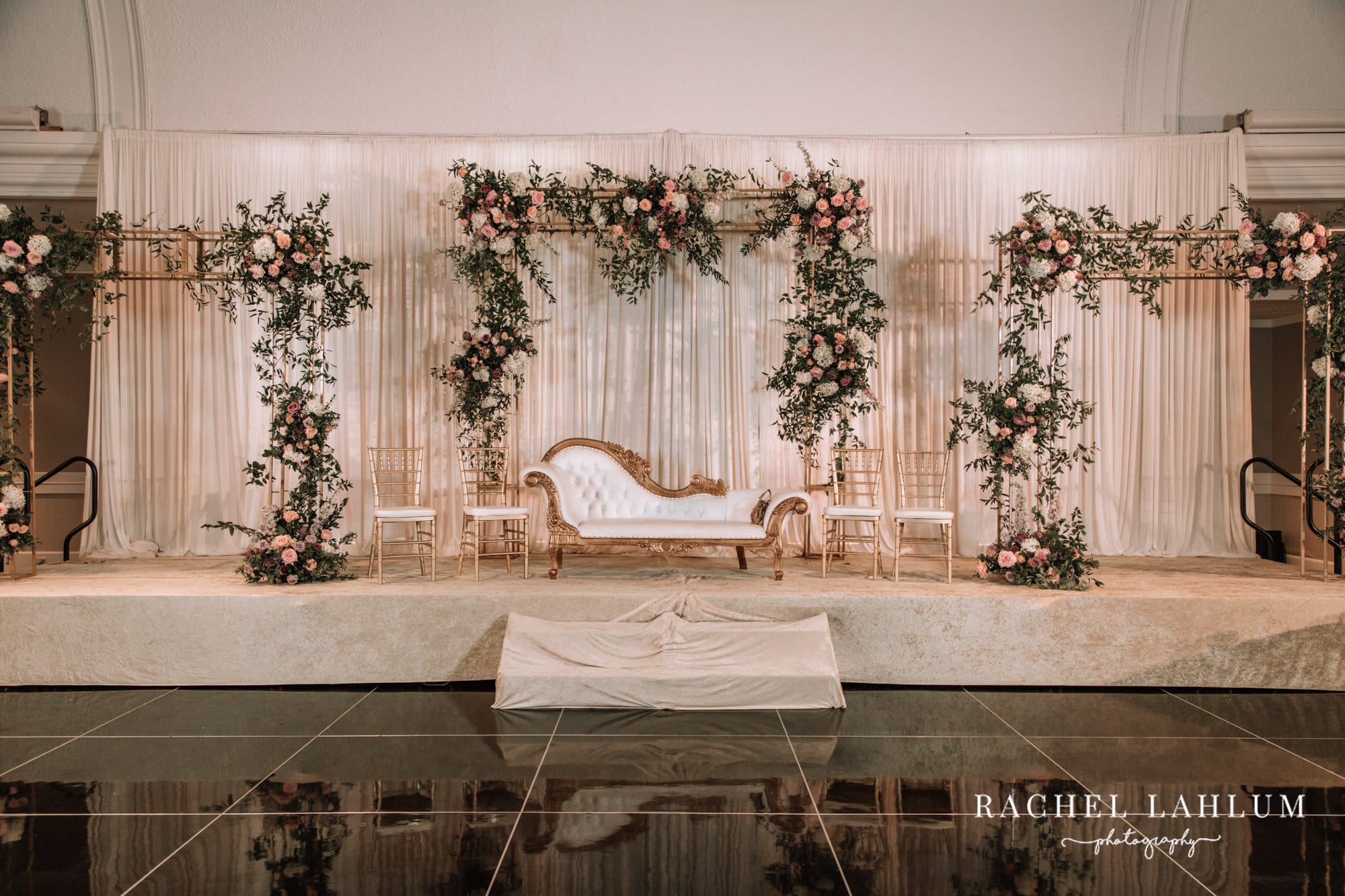 A decadent white couch sits on a stage before Walima celebration at the Intercontinental in St. Paul. 