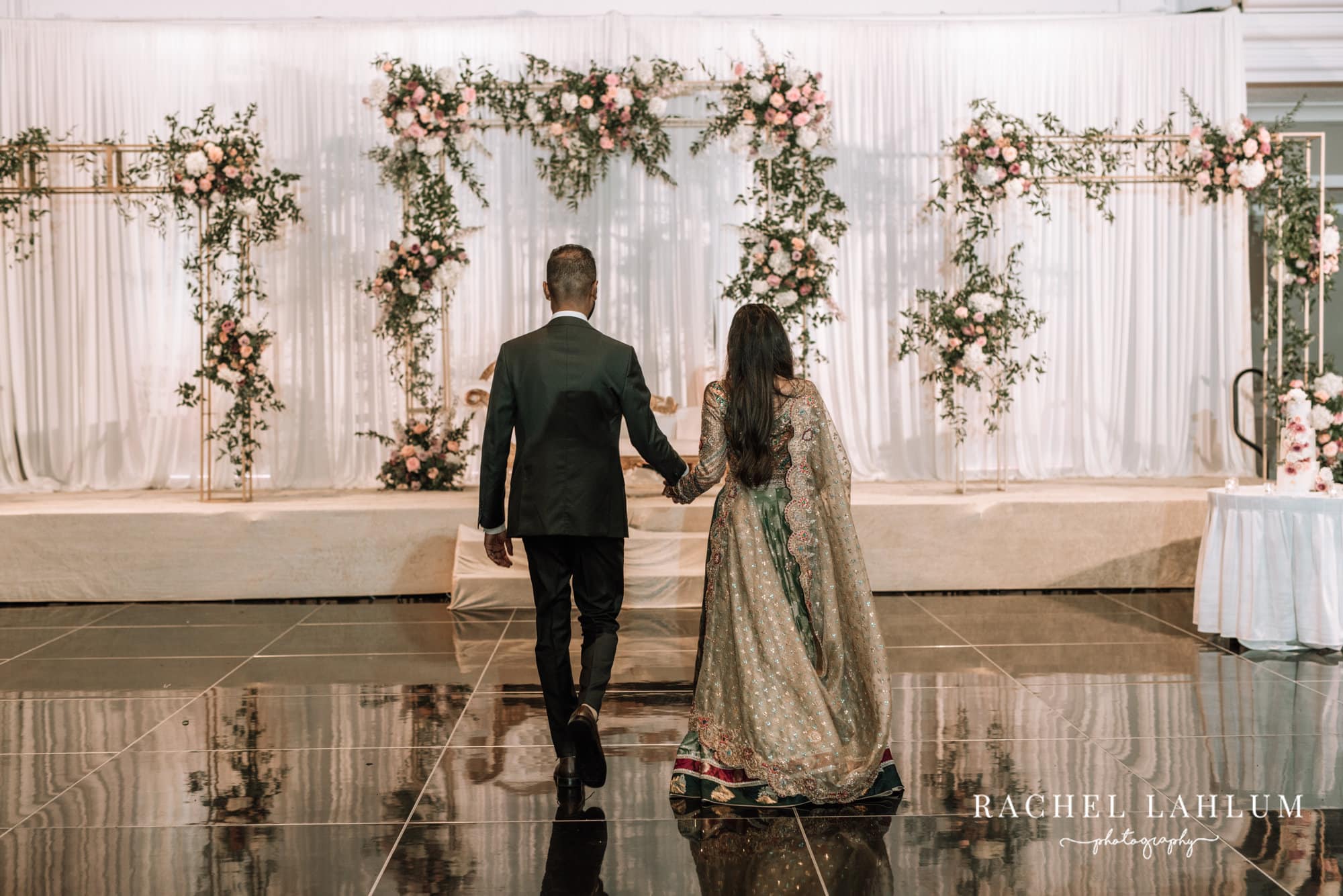 Bride and groom walk towards the stage for Walima celebration at the Intercontinental.