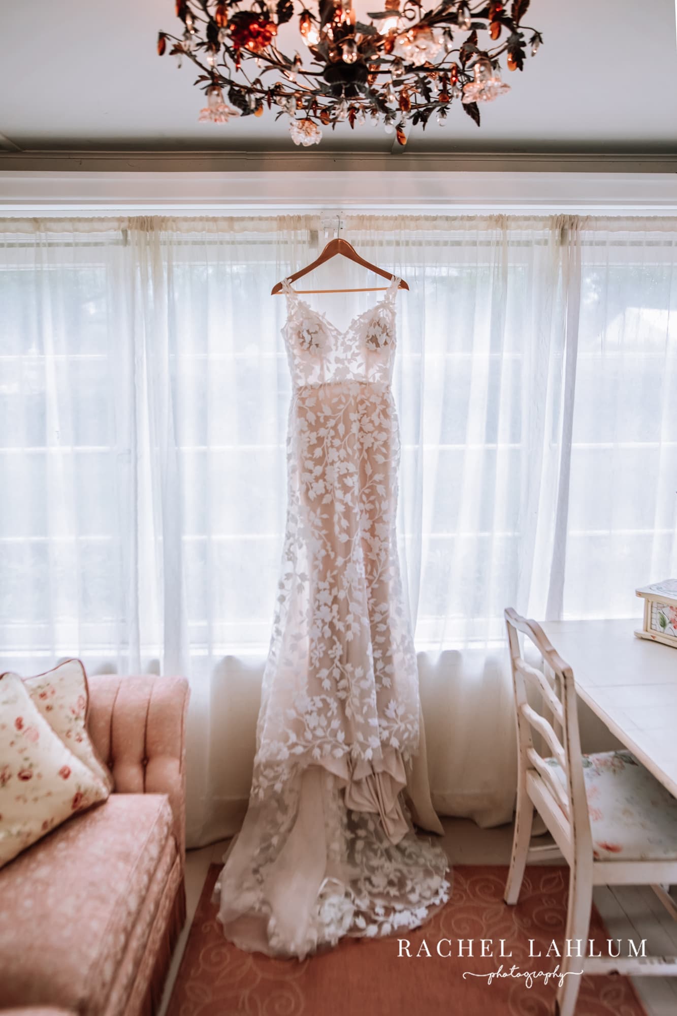 Bride’s dress hanging from a window at Camrose Hill Flower Farm in Stillwater, Minnesota.