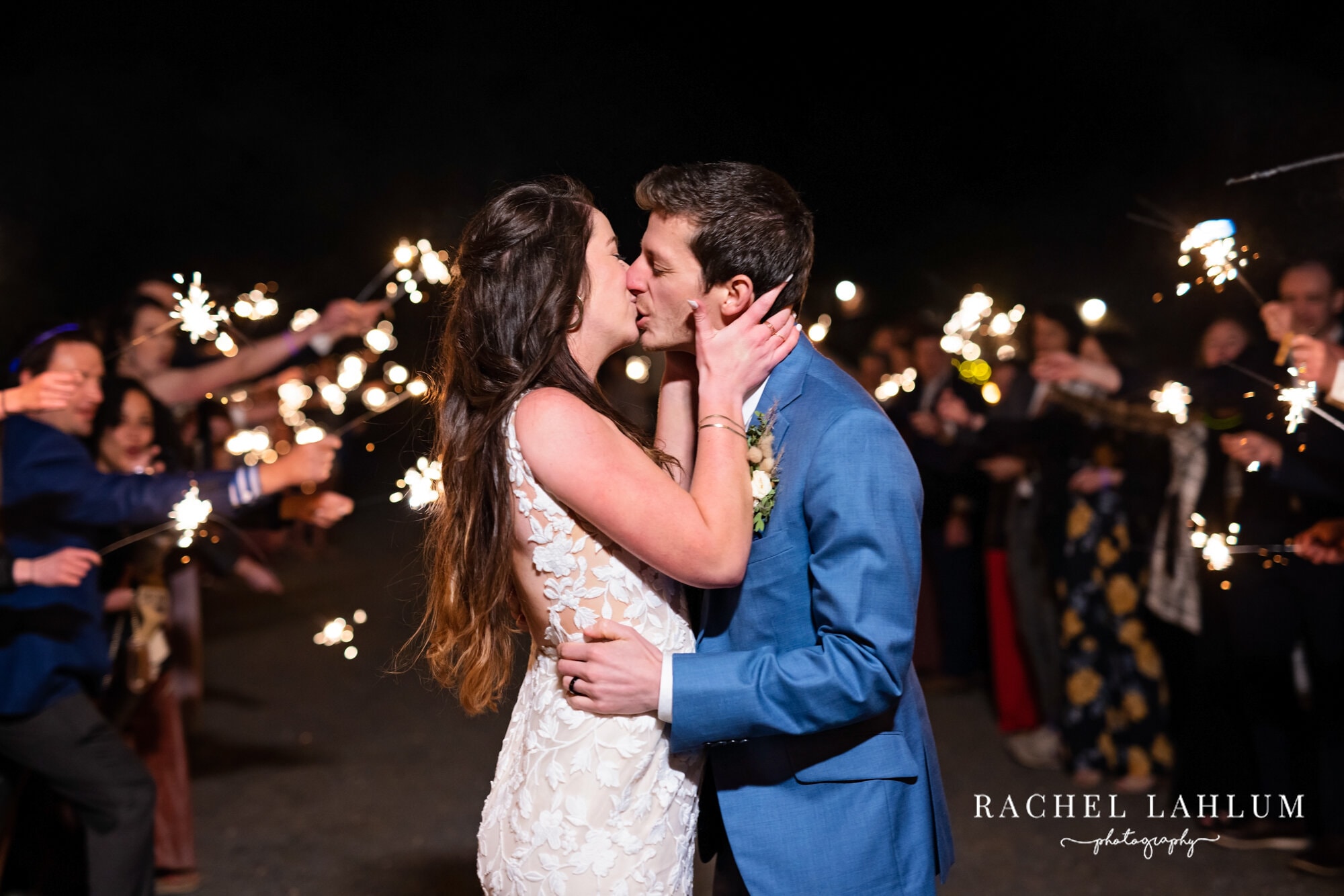 Newlyweds kiss at the end of a sparkler tunnel at Camrose Hill Flower Farm.