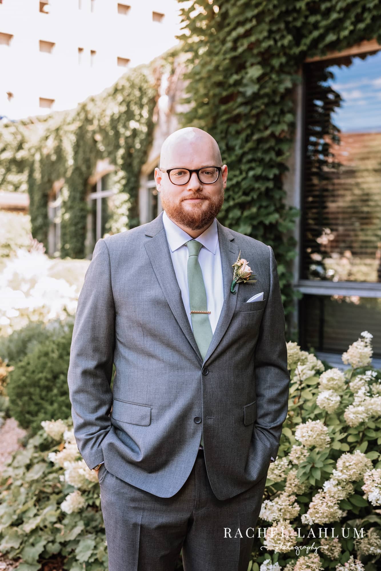 Groom poses for portrait before wedding at Harriet Island Pavilion. 