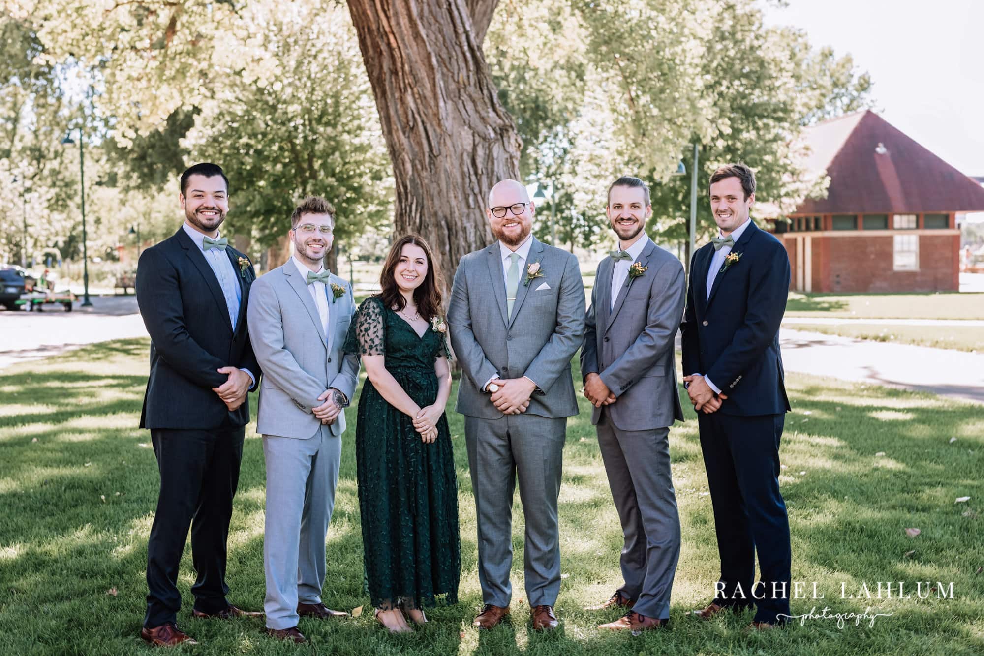 Groom and friends of honor pose under a tree at Harriet Island Pavilion. 