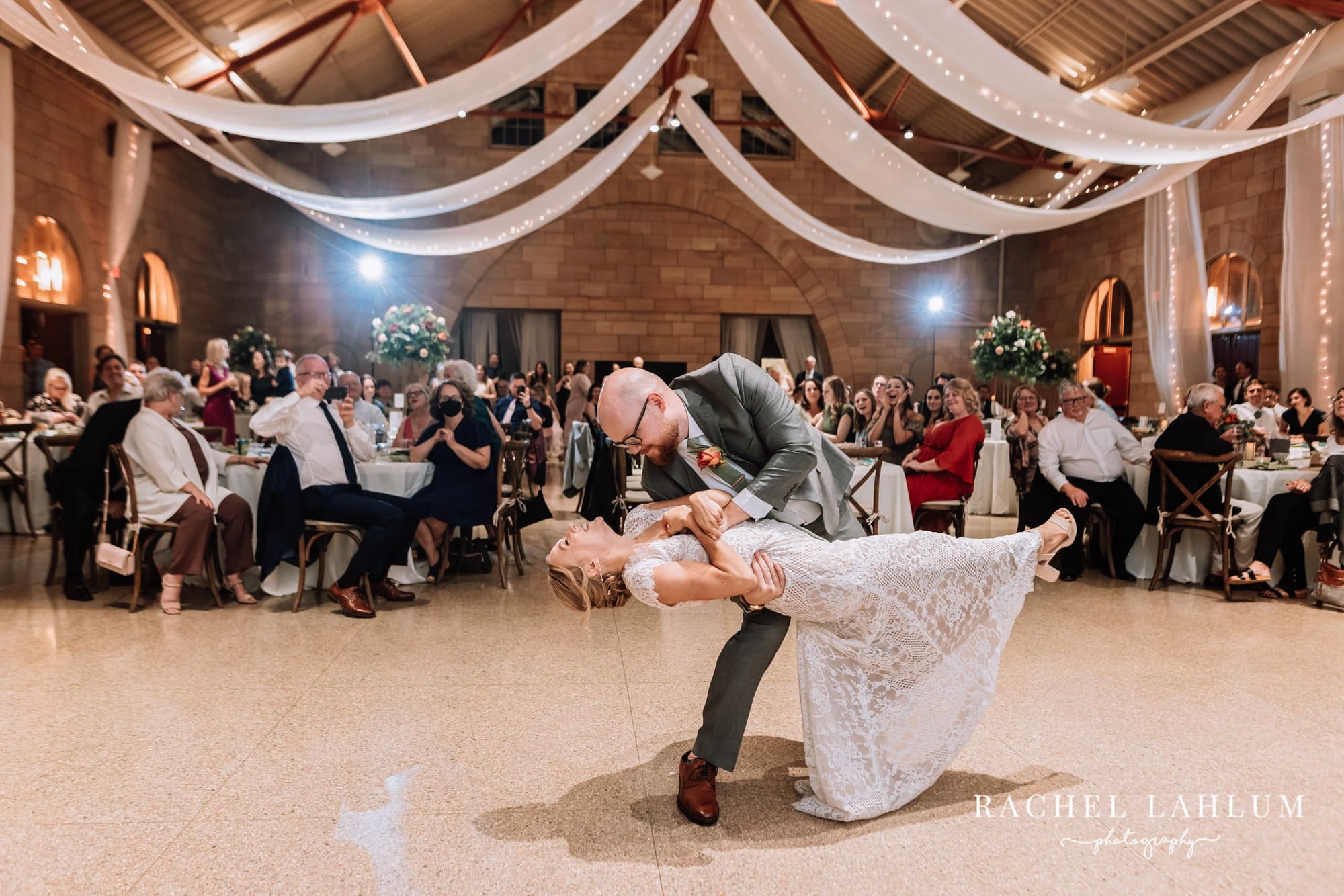 Groom dips bride during first dance at Harriet Island Pavilion wedding. 