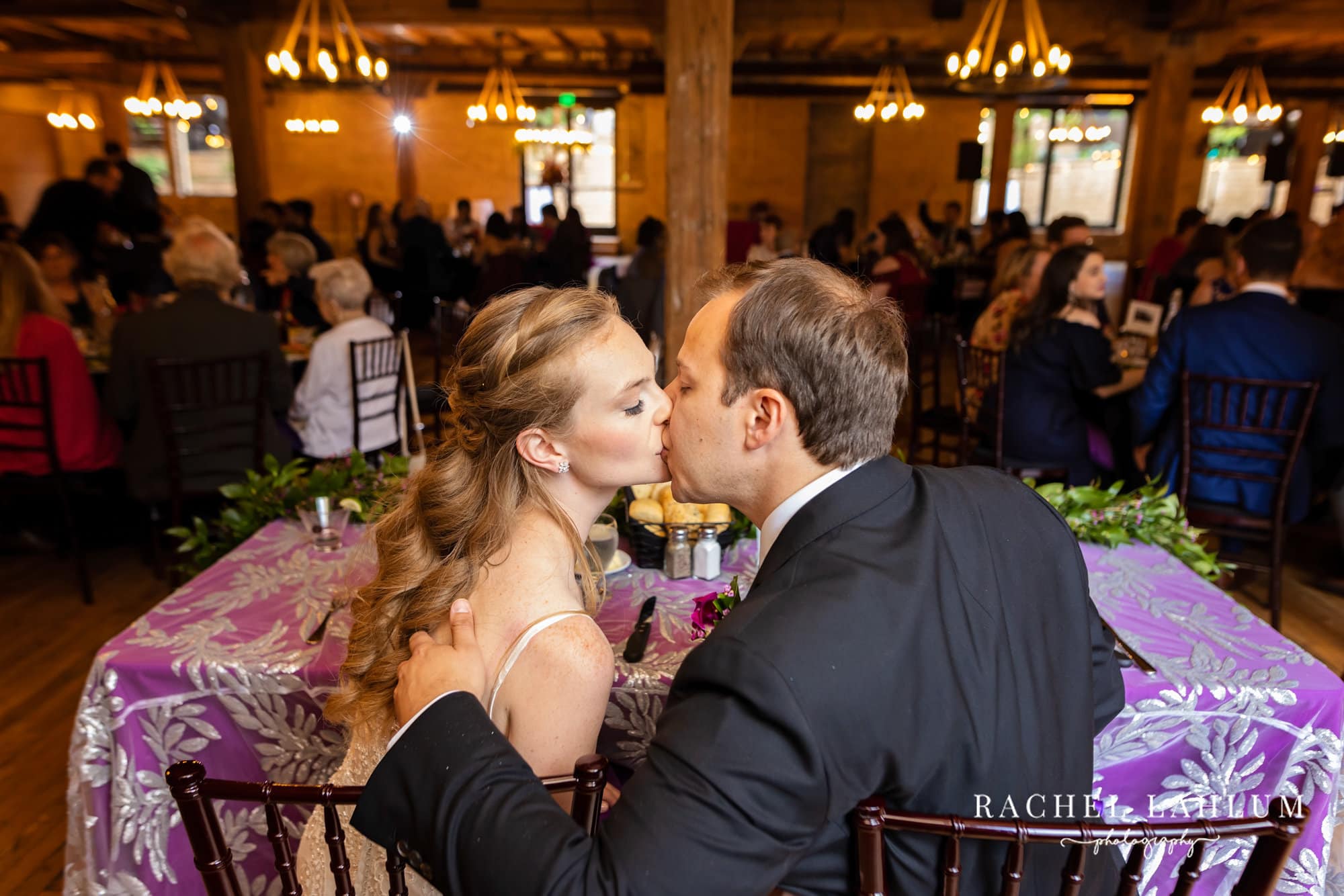 Bride and groom kiss before reception dinner. 