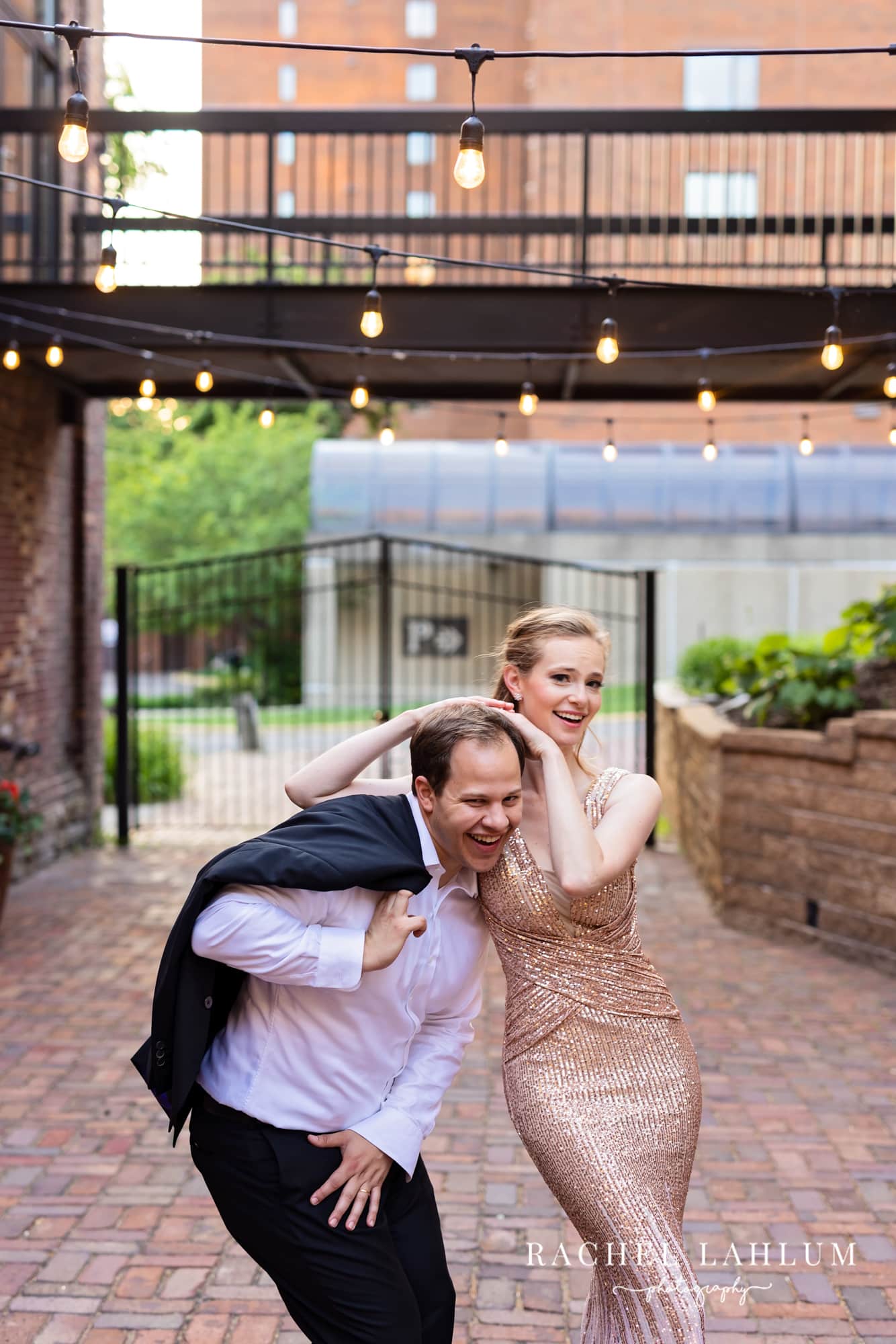 Newlyweds make a silly pose in the courtyard of The Minneapolis Event Center.