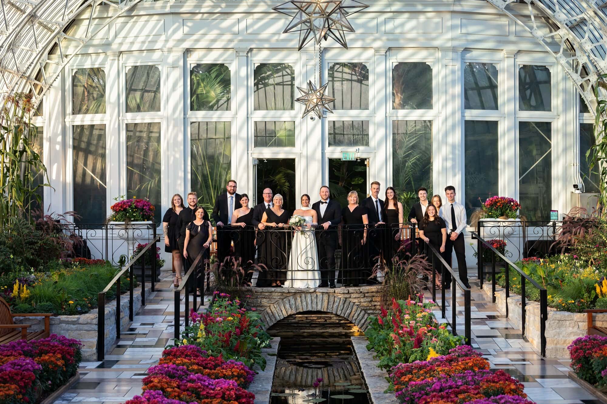 A group wedding photo at Como Conservatory Sunken Garden in St Paul, MN.