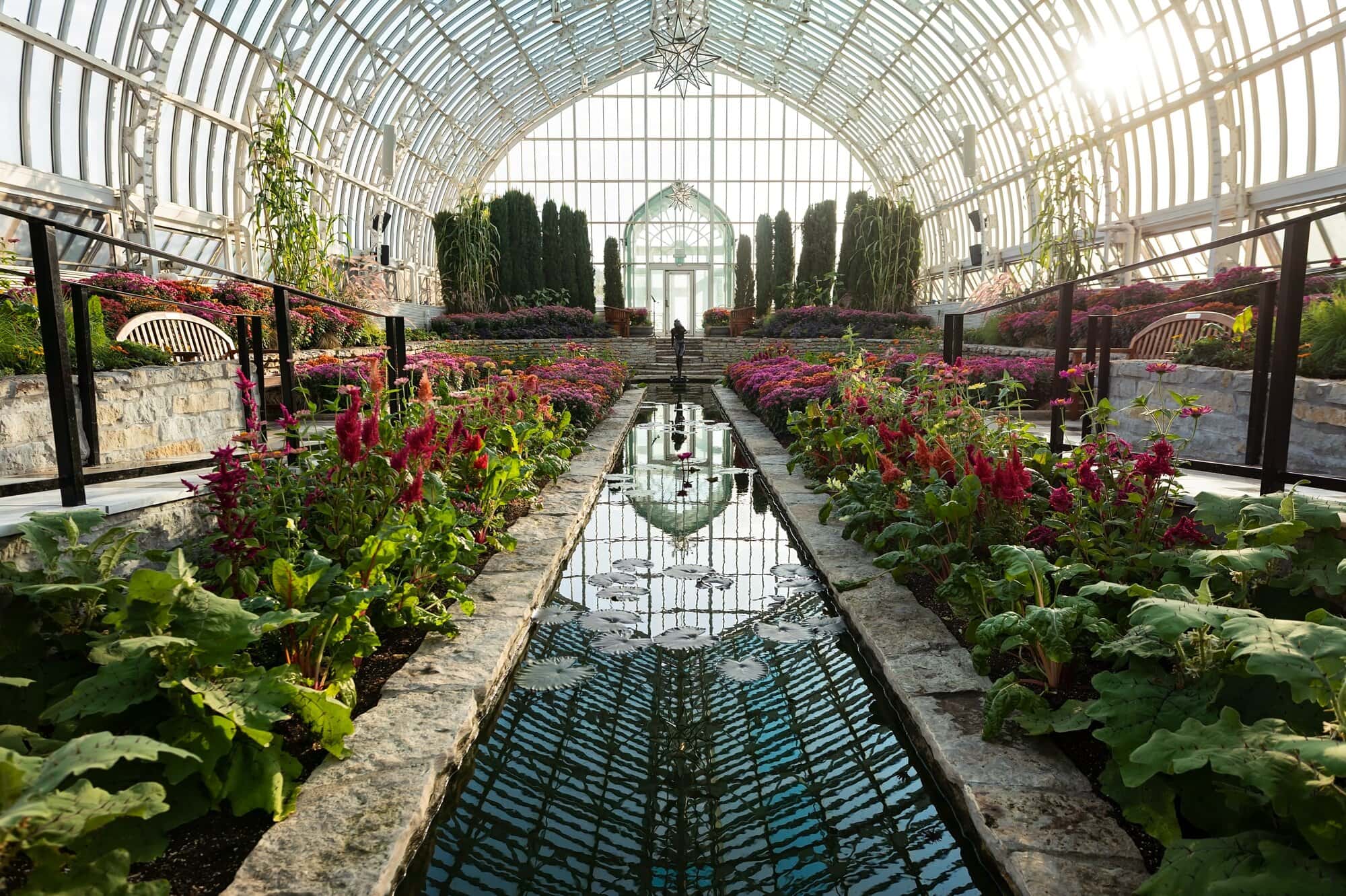 A wide angle photo of Como Conservatory Sunken Garden during golden hour in St Paul, MN