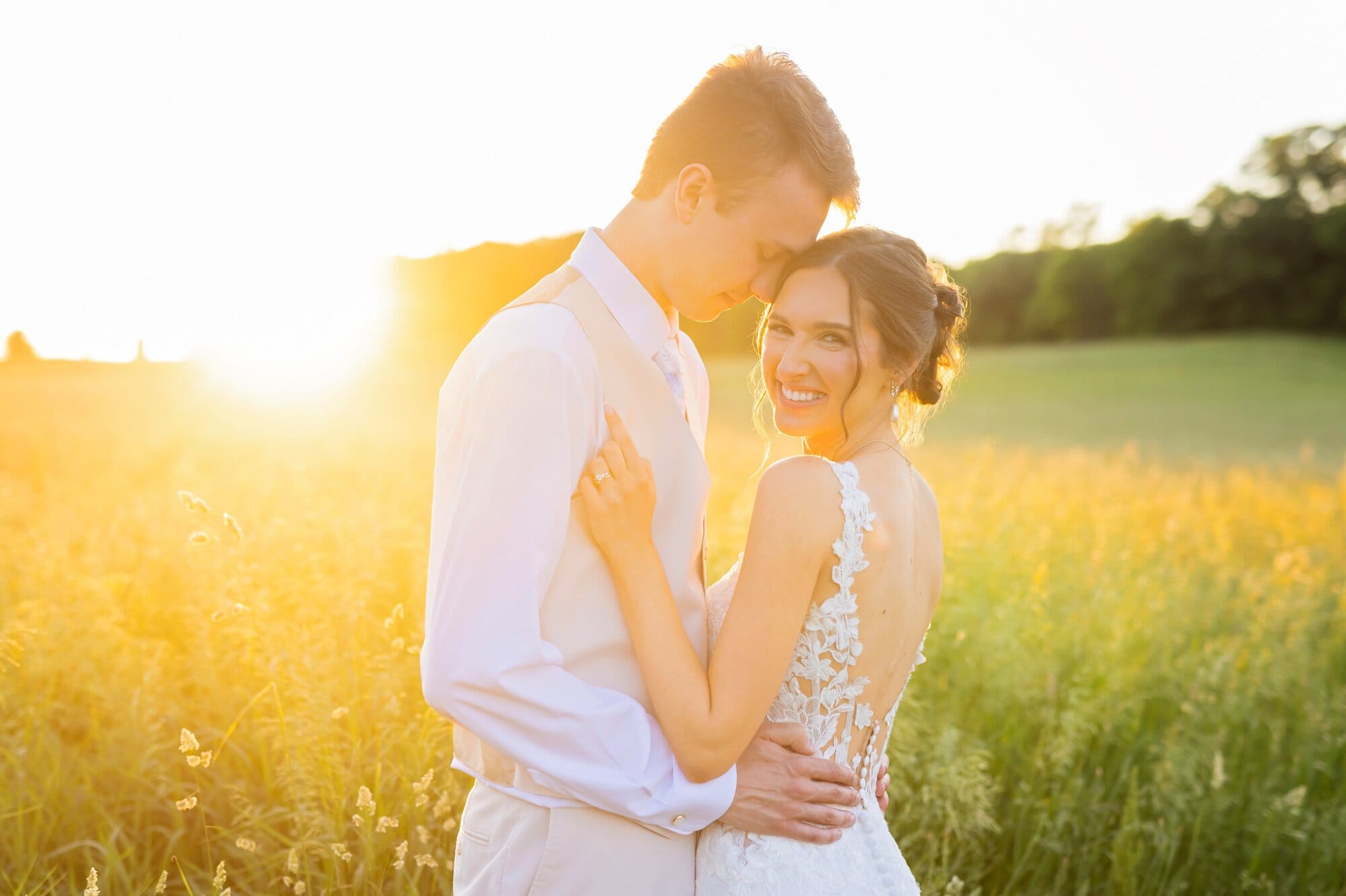Newlyweds sharing a romantic sunset moment during outdoor wedding portraits at Ridgetop Events in Prescott, Wisconsin.