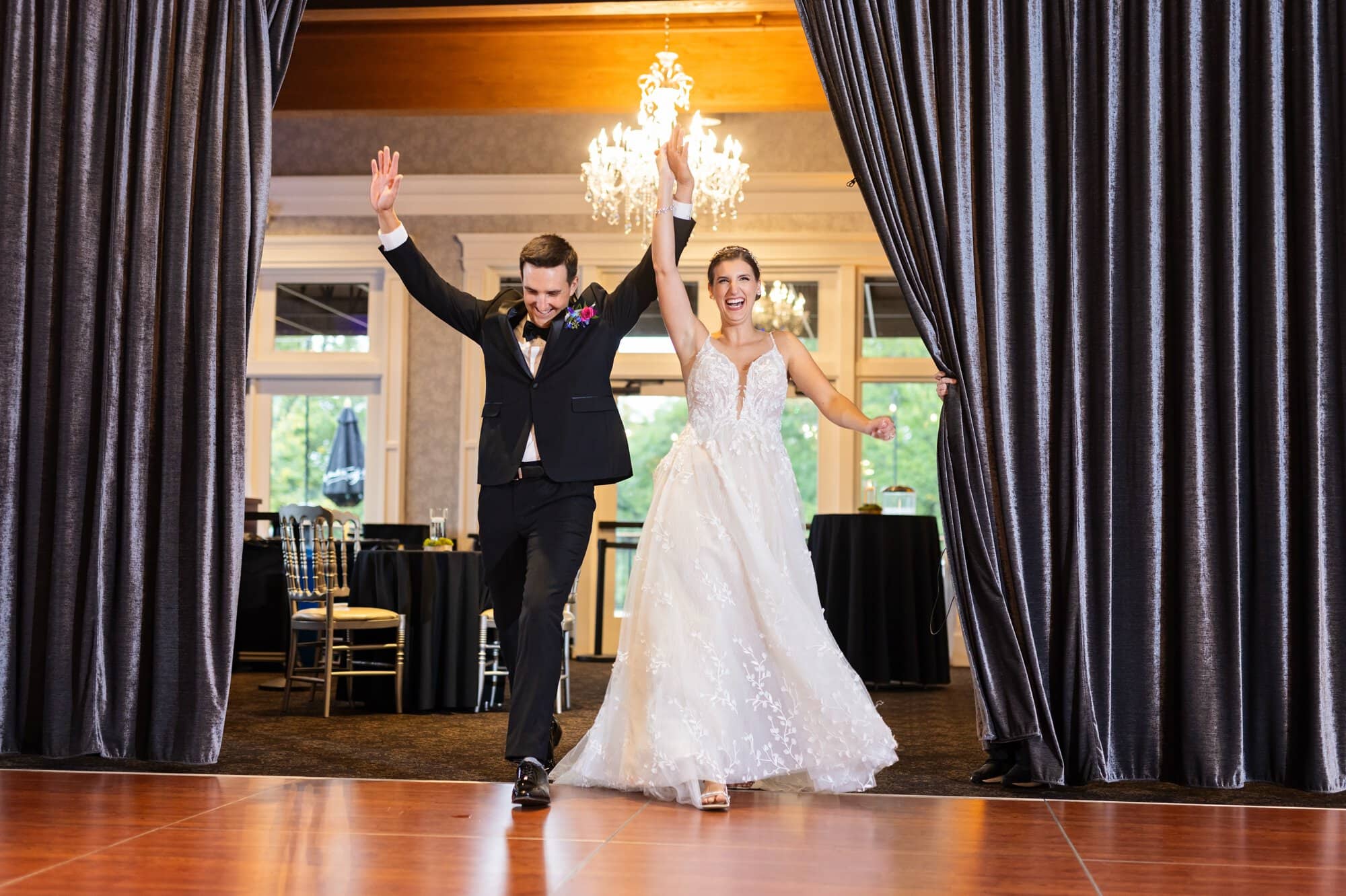 Bride and groom triumphantly make an entrance into the reception hall at Leopold's Mississippi Gardens, NE Minneapolis