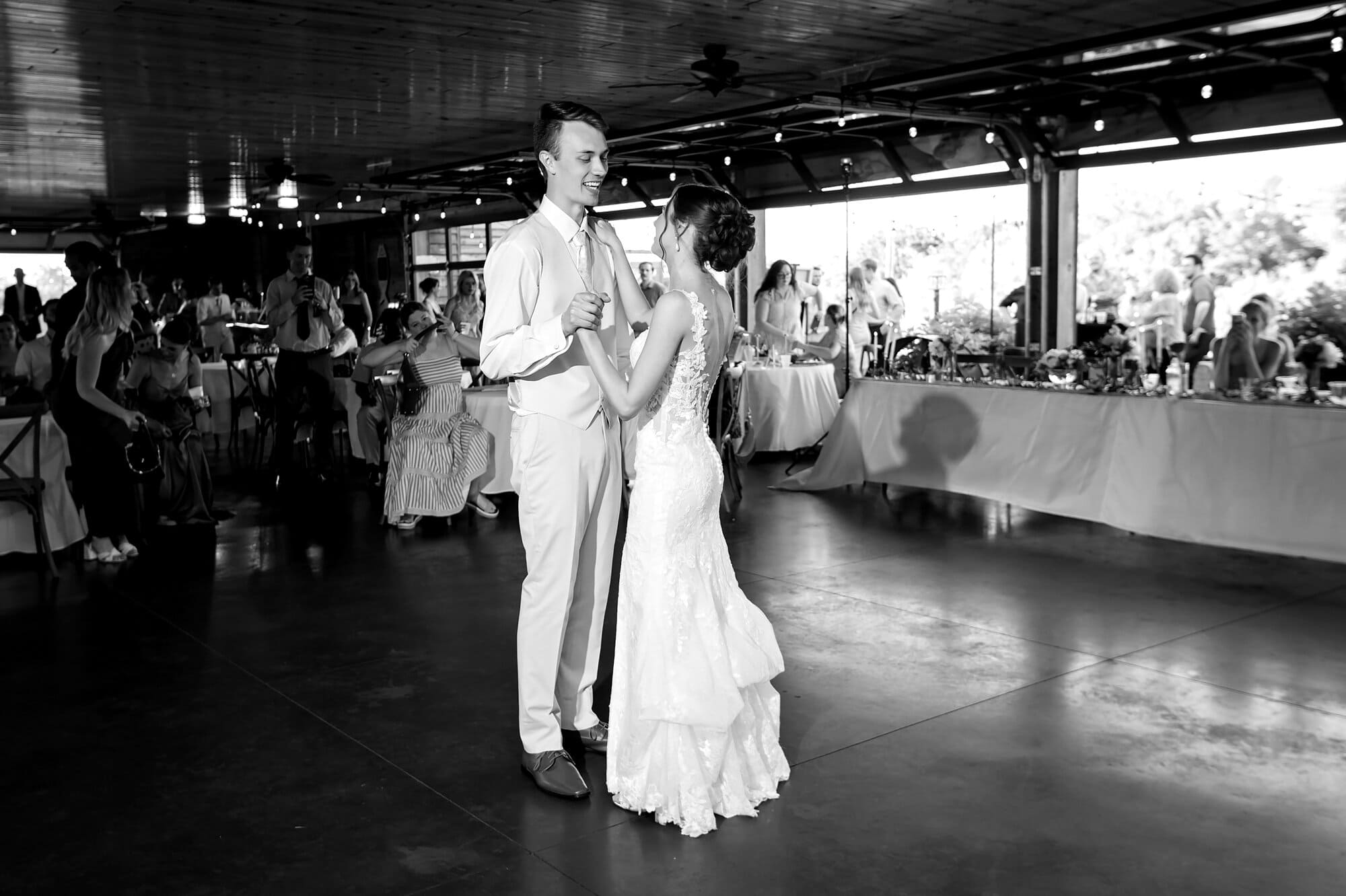 Black and white photo of the first dance of the bride and groom as a couple for their wedding at Ridgetop Events in Prescott, WI.