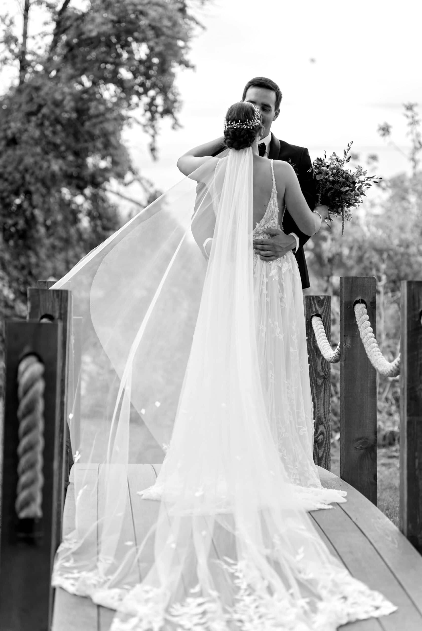 Bride and groom slow dancing on a bridge for black and white wedding portaits in Leopold's Mississippi Gardens, NE Minneapolis