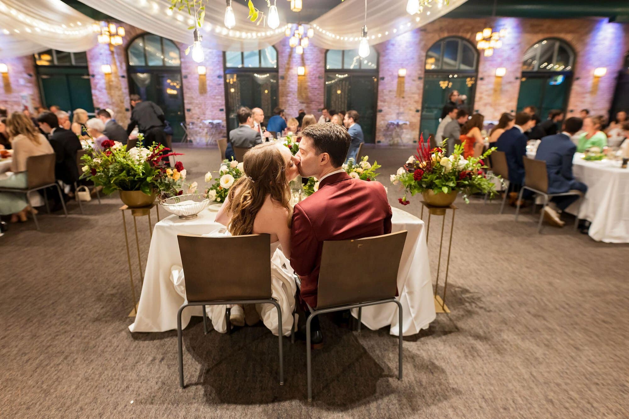 Bride and groom kiss during the reception at Nicollet Island Pavilion in Minneapolis Minnesota