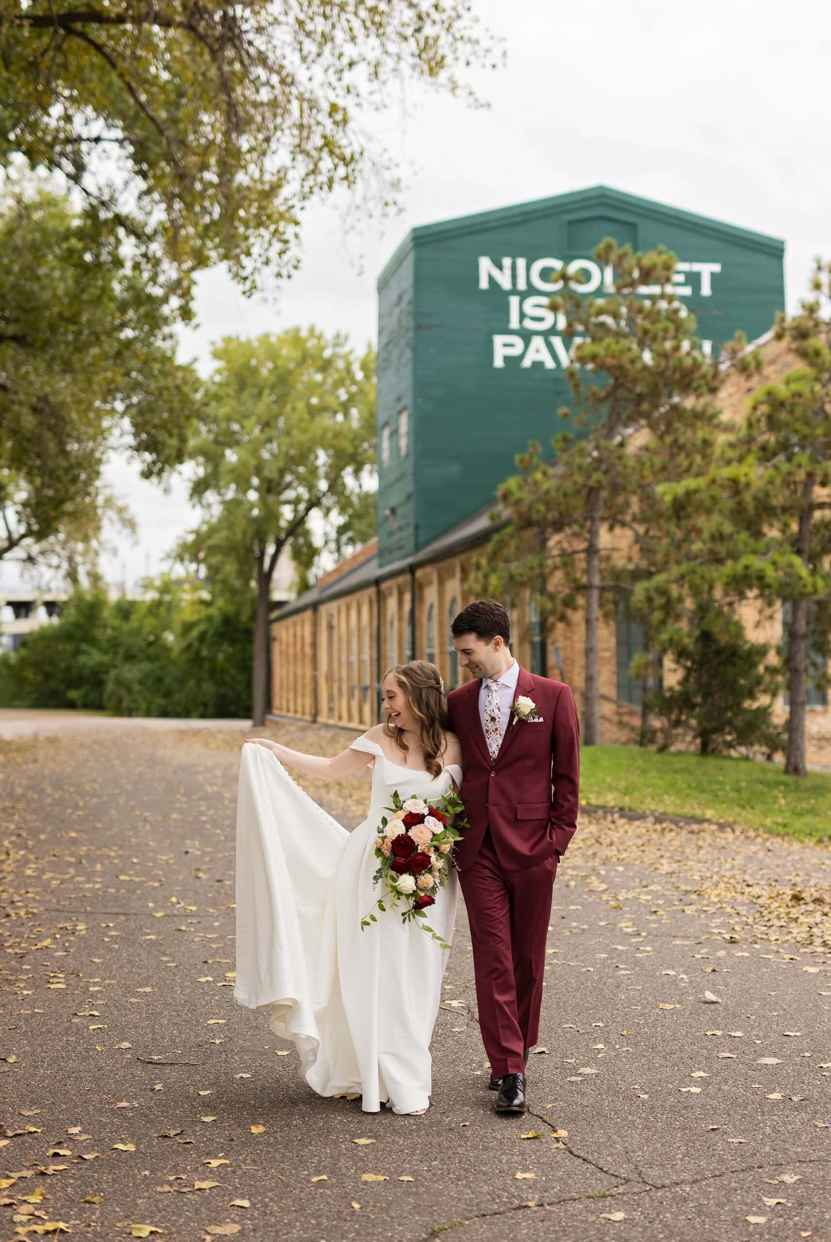 Bride and groom walking together for their wedding photography at the Nicollet Island Pavilion in Minneapolis, MN.