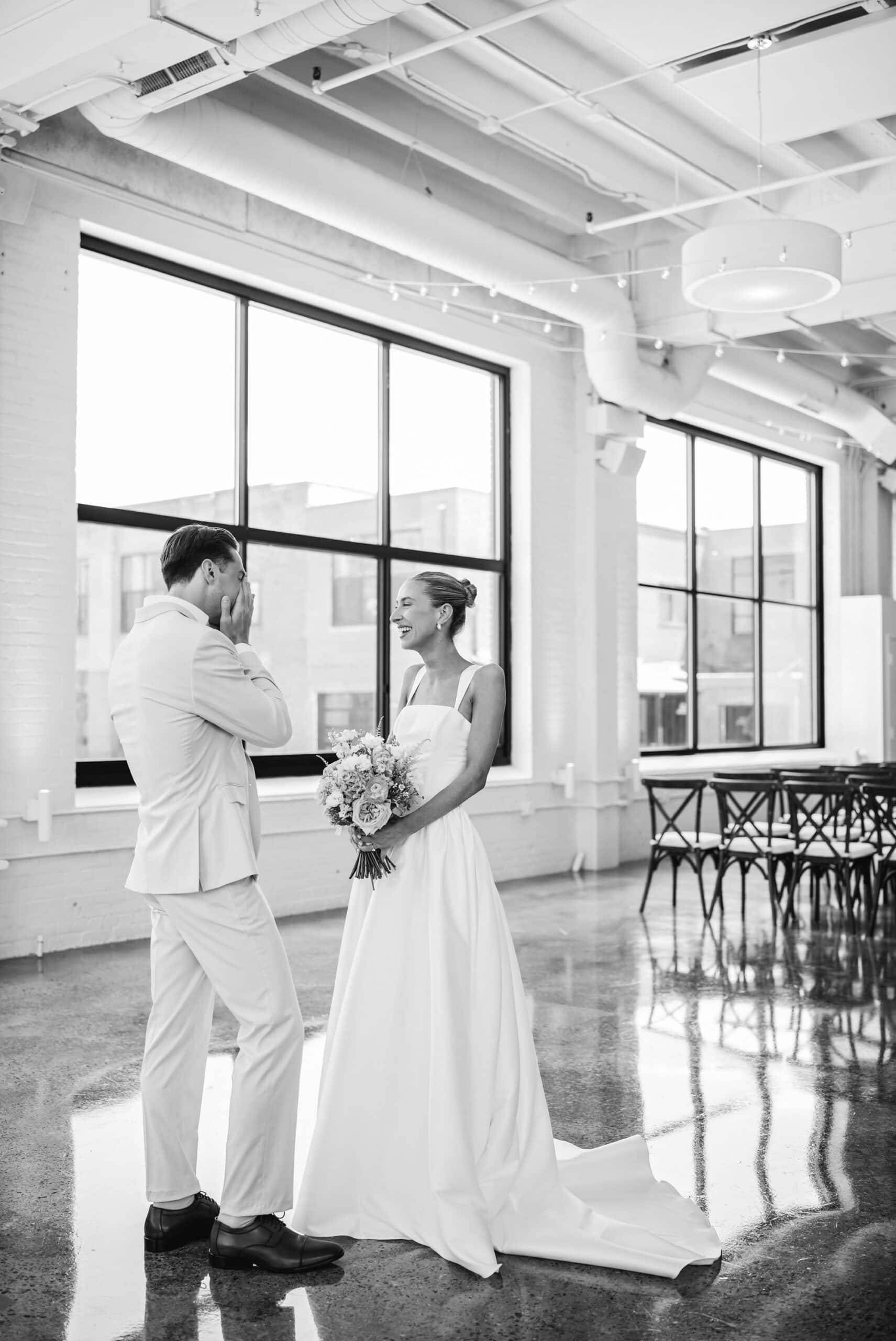 Bride and groom share laughter and tears during their first-look portraits at the Urban Daisy in Minneapolis, Minnesota