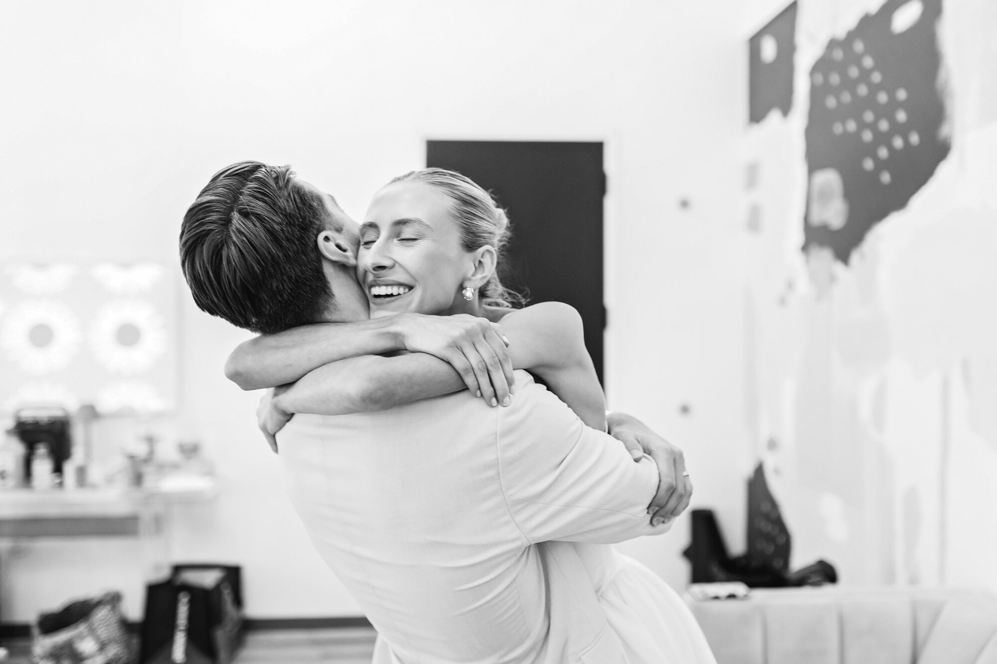 Bride and groom embrace in a black and white post-ceremony photo at a relaxed Urban Daisy wedding in Minneapolis, MN