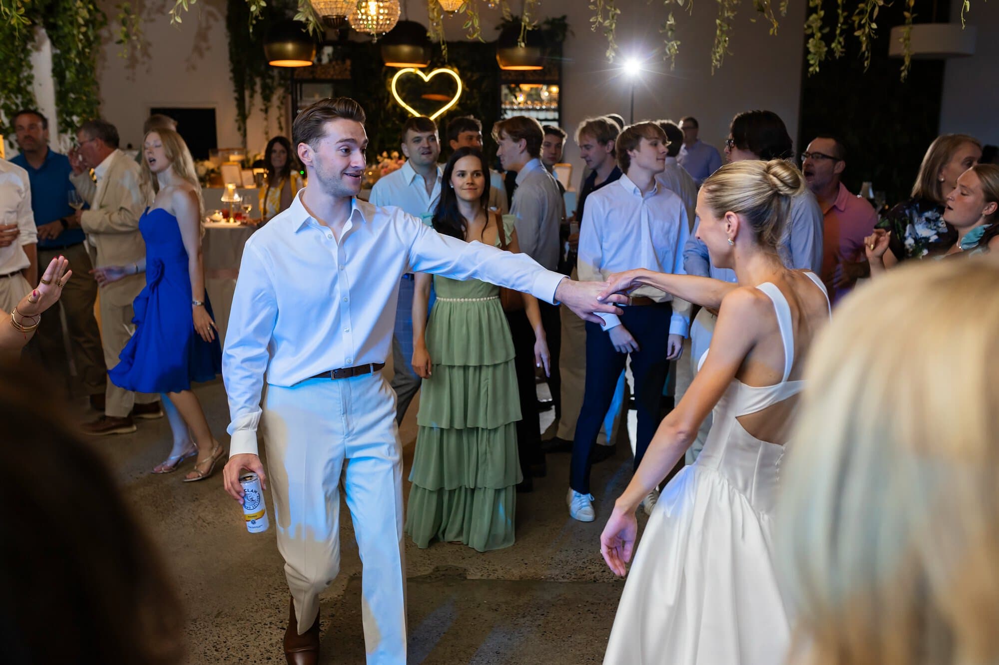 Bride and  groom dance during their relaxed Urban Daisy wedding reception in Minneapolis, Minnesota
